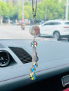 This Multicolored Gemstone Car Ornament adds a touch of luxury to your ride. Made with genuine gemstones, this ornament adds a unique and elegant touch to any vehicle. Give your car a customized look and make a statement with this ornament. Elevate your driving experience with a touch of luxury.