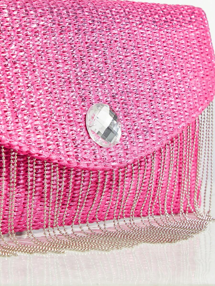 Close-up view of chic metallic coated straw woven clutch bag with chain and tassel - ideal for summer vacations with metallic finish, woven straw texture, woven texture for vacation styling