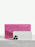 Close-up view of chic metallic coated straw woven clutch bag with chain and tassel - ideal for summer vacations with metallic finish, woven straw texture, woven texture for vacation styling
