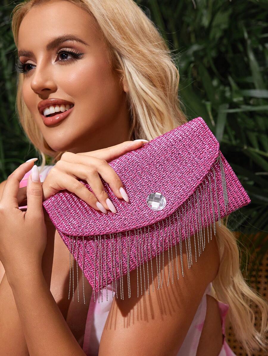 Close-up view of chic metallic coated straw woven clutch bag with chain and tassel - ideal for summer vacations with metallic finish, woven straw texture, woven texture for vacation styling