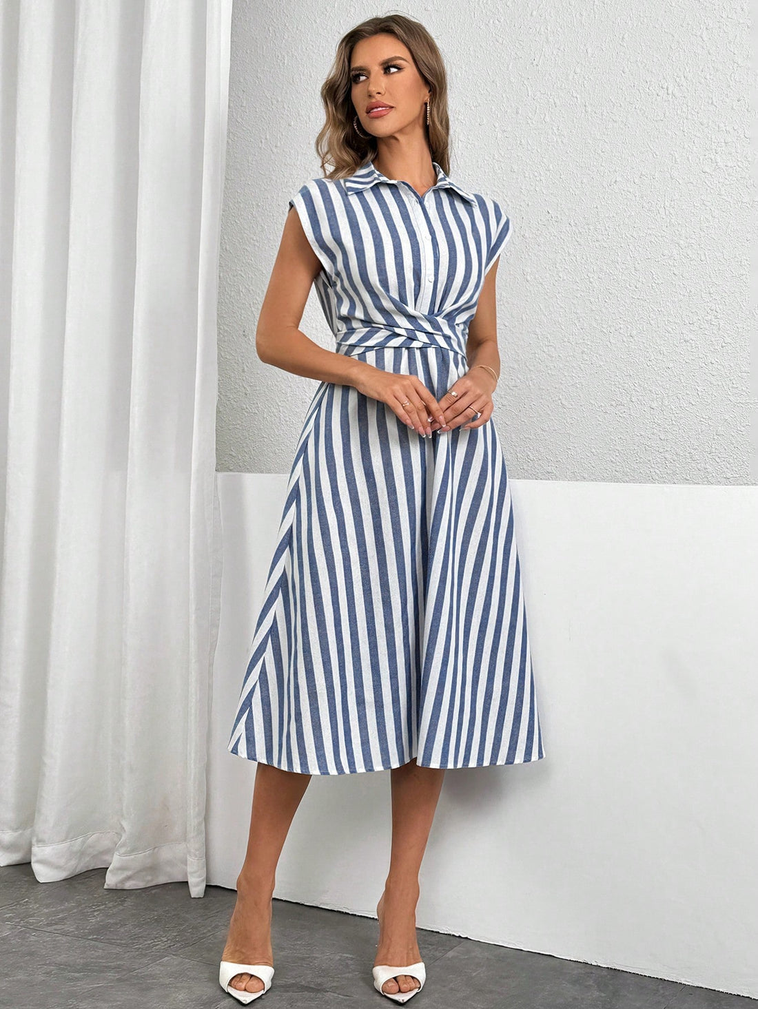 Sail into spring and summer with timeless elegance in our Blue and White Striped A-Line Midi Dress. Perfect for any occasion, this dress exudes a playful yet sophisticated vibe. Embrace a chic and breezy style with this must-have dress.