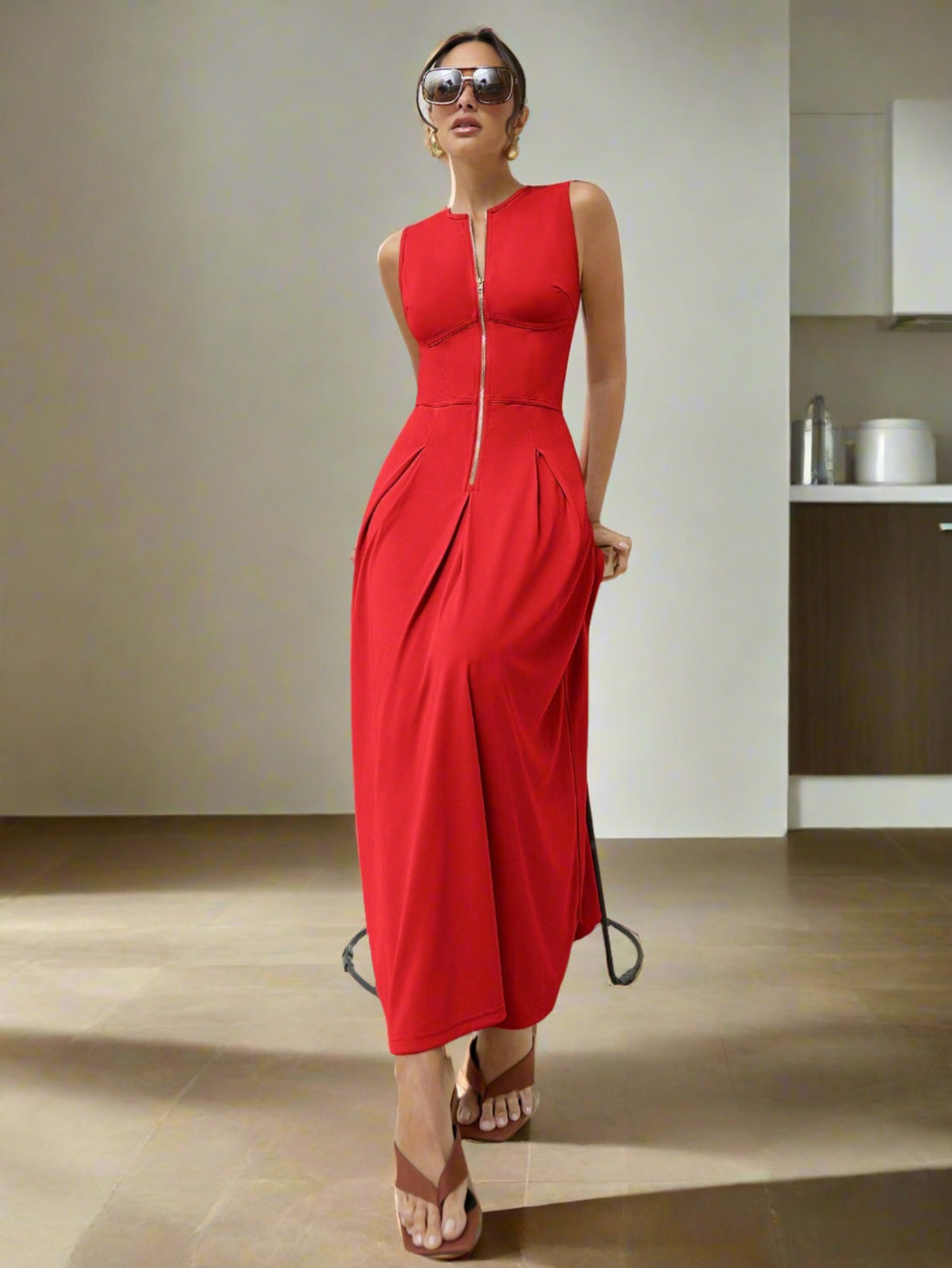 Achieve a sophisticated and stylish look in our Chic Sleeveless Long Dress. This elegant piece features a gold zipper waist detail that adds a touch of glamour to the solid color design. With its sleeveless cut, this dress is perfect for warm weather occasions.