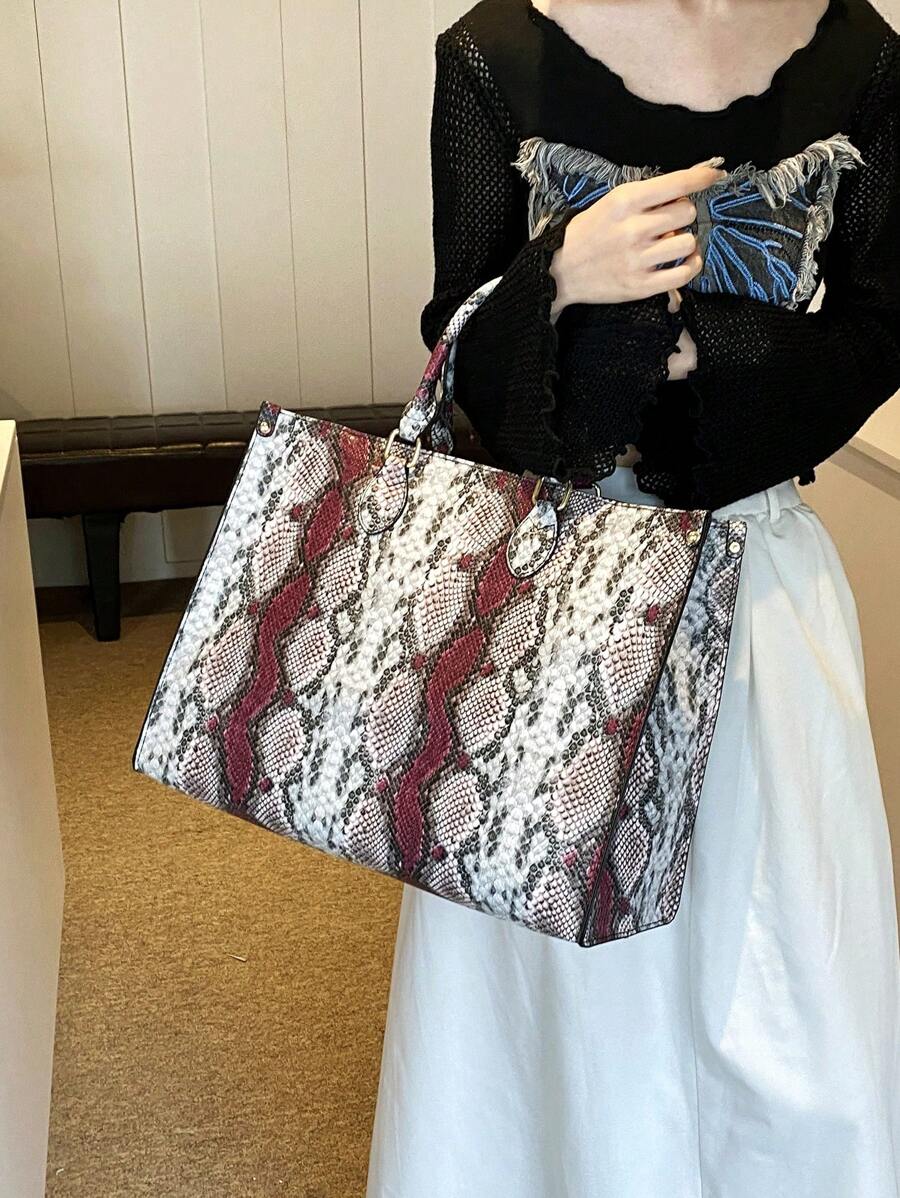 Slither into style with our eye-catching snake print oversized tote! This versatile companion handles everything from weekend getaways to grocery runs with effortless flair. The spacious interior keeps your essentials organized, while the bold reptilian pattern adds instant personality to any outfit. Durable construction means it's ready for year-round adventures, whether you're jet-setting or just hitting the shops. Perfect for anyone who refuses to blend in!