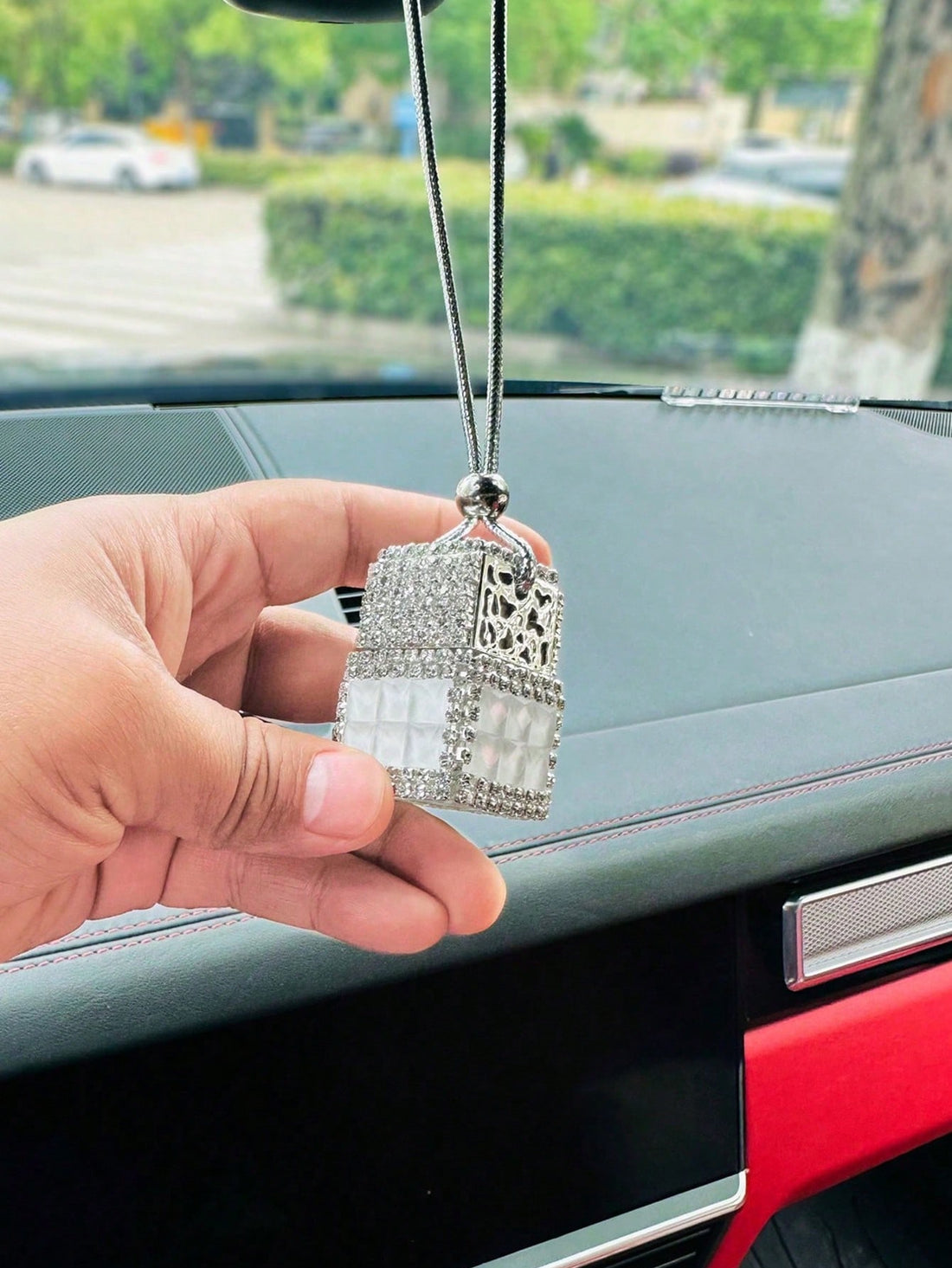 Add some bling to your car with our stunning rhinestone-studded pendant! Made with high-quality materials, this decorative piece will catch the light and add a touch of glamour to your ride. Elevate your style and shine wherever you go. Perfect for car enthusiasts or as a gift for someone special.