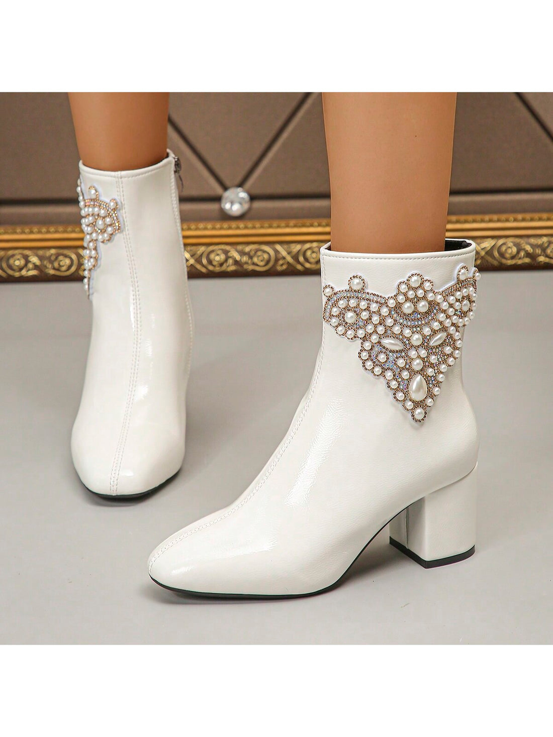 These stylish women's short boots feature a sleek and chic design, complete with a chunky heel and glossy leather material. The slim zipper adds a touch of sophistication to these boots, making them perfect for any fashionable individual. Enjoy both style and comfort with these versatile boots.