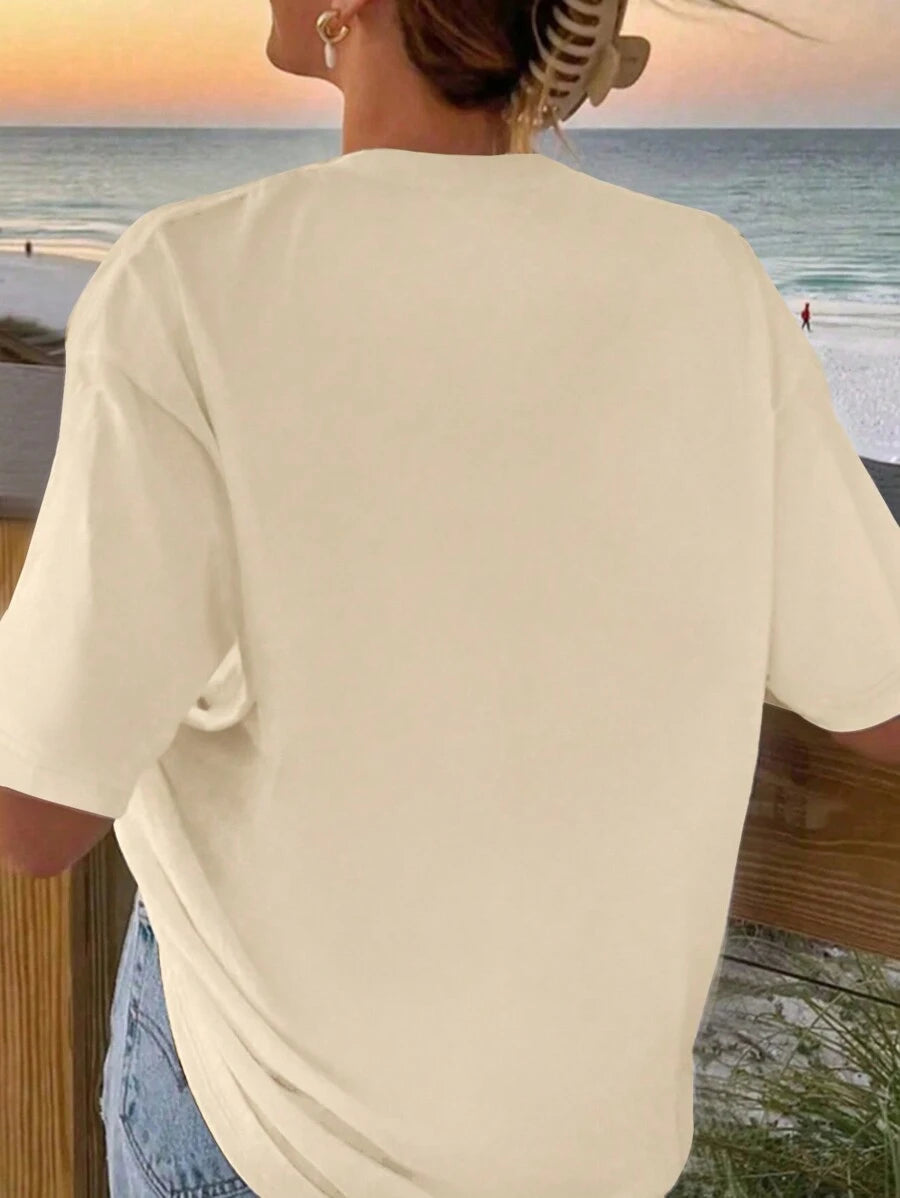 Front view of apricot oversized sea life graphic tee with pastel ocean animal shell and coral print