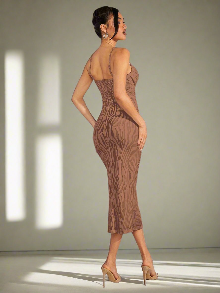 This cami dress features a striking zebra print and a daring split thigh design, making it the perfect choice for those looking to turn heads with their fashion. The haute style of this dress exudes confidence and sophistication, making it a must-have for any fashion-forward individual. 