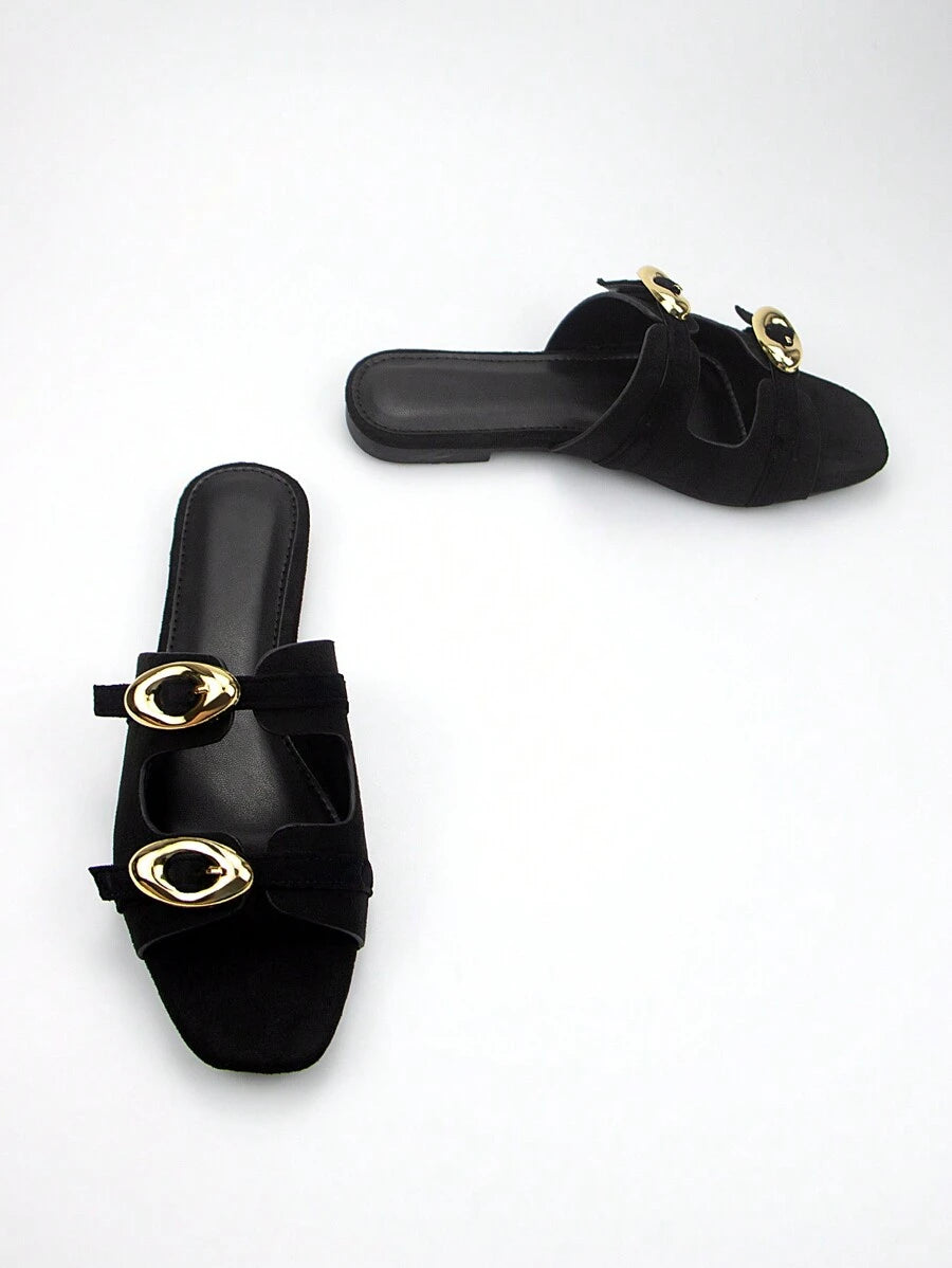 Elevate your everyday wardrobe with these sophisticated black suede mules, designed for effortless versatility. The adjustable strap with gleaming gold-tone buckle offers a customizable fit while adding a refined touch of elegance. Crafted from premium suede, these flat mules deliver comfort without compromising on style, making them an ideal choice for transitioning seamlessly from casual outings to more polished occasions. The minimalist silhouette pairs beautifully with dresses, jeans, or tailored trouse