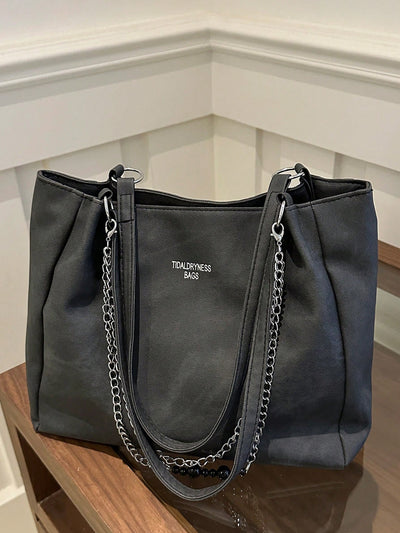 The Versatile Chain-Decor Tote Bag is the perfect travel and everyday companion. With its sleek design and durable materials, it can keep up with your busy lifestyle. The versatile chain decoration adds a touch of style while the spacious interior provides ample storage for all your essentials.