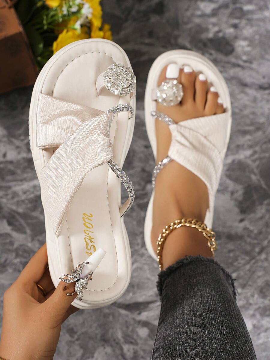 White platform rhinestone slide sandals with thick molded sole and crossover straps