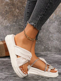 Side view of white platform thong sandals with jeweled toe detail and ridged sole