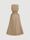 Back view of khaki midi dress with structured bodice and full skirt
