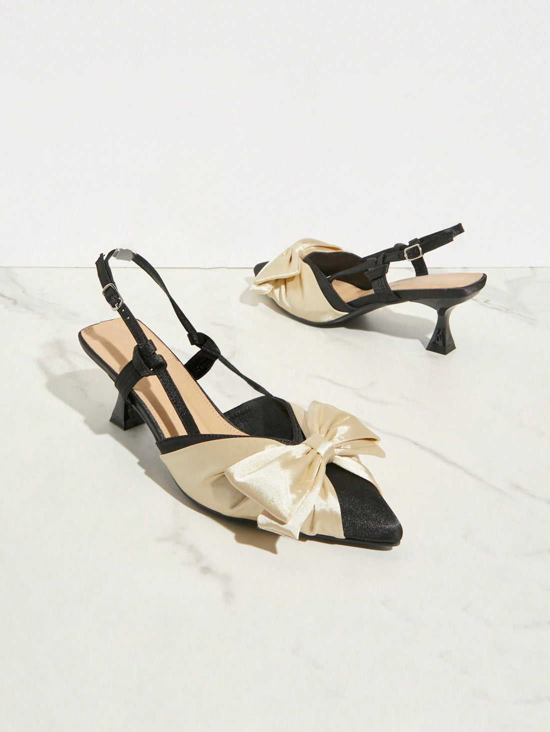 These elegant stiletto heels feature a beautiful bow design, adding a touch of sophistication to any dressy occasion. Crafted with quality and style in mind, these heels are the perfect addition to any woman's wardrobe. Elevate your look with these stylish and versatile heels, sure to make a lasting impression.