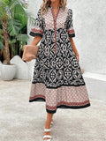 Black geometric print midi dress front view with red and white pattern