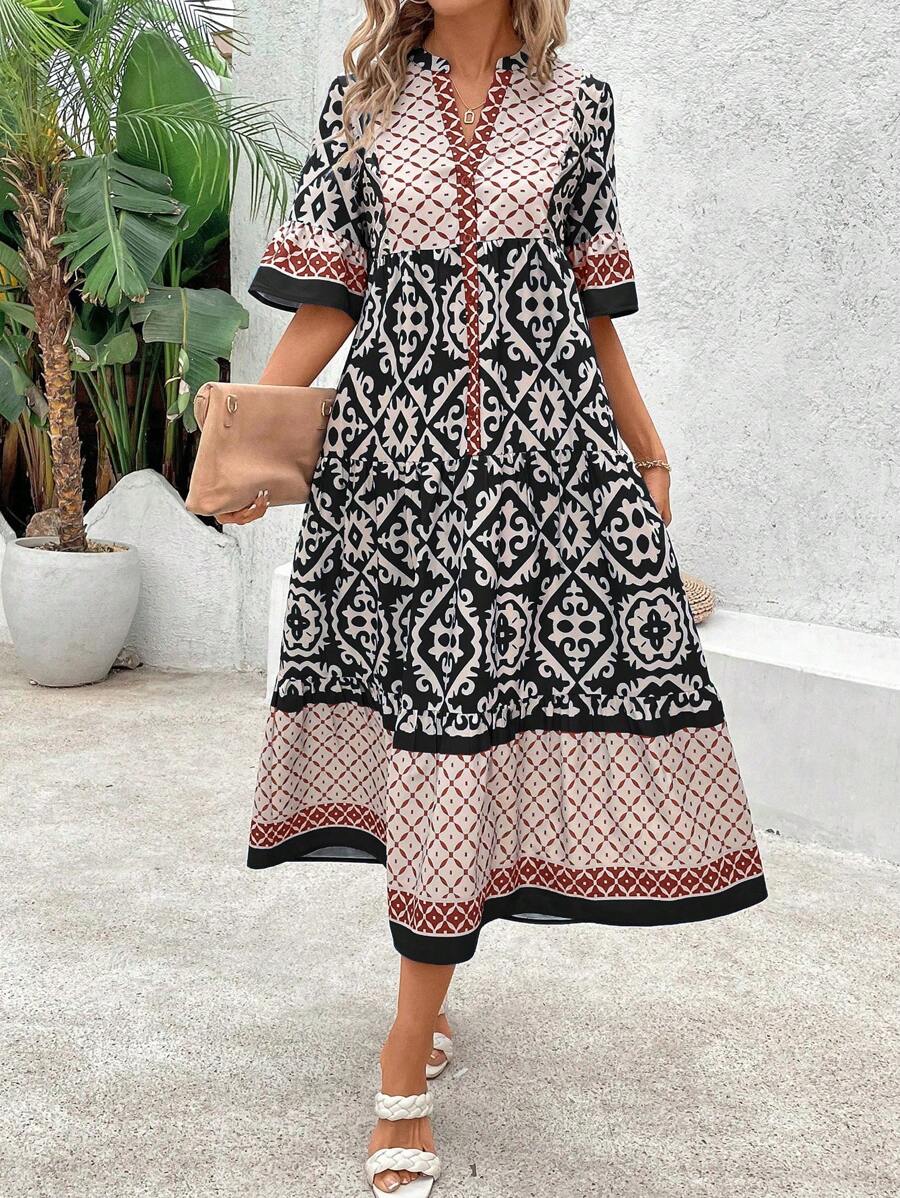 Black geometric print midi dress front view with red and white pattern