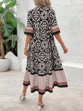 Back view of black boho printed dress with loose smock shape
