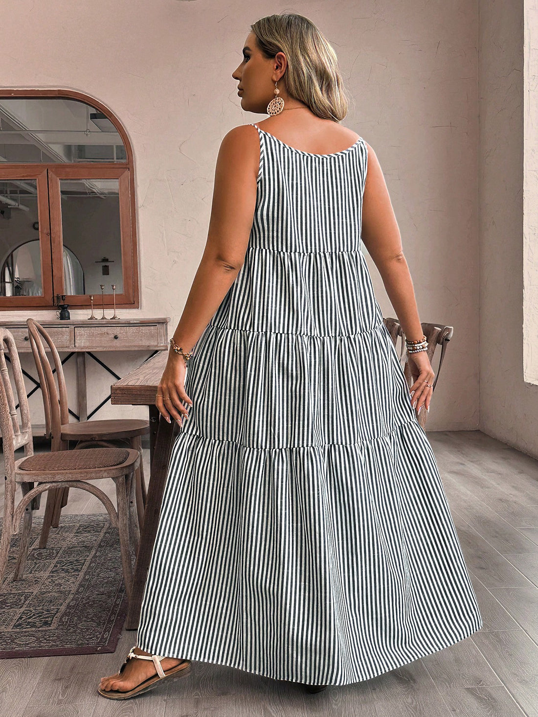 Get ready to strut your stuff in this Chic & Flowy Plus Size Striped Ruffle Hem Cami Dress. With its eye-catching stripes and playful ruffle hem, this dress is sure to turn heads. The flowy fit and comfortable fabric make it perfect for any occasion. Time to dress to impress (and have some fun)!