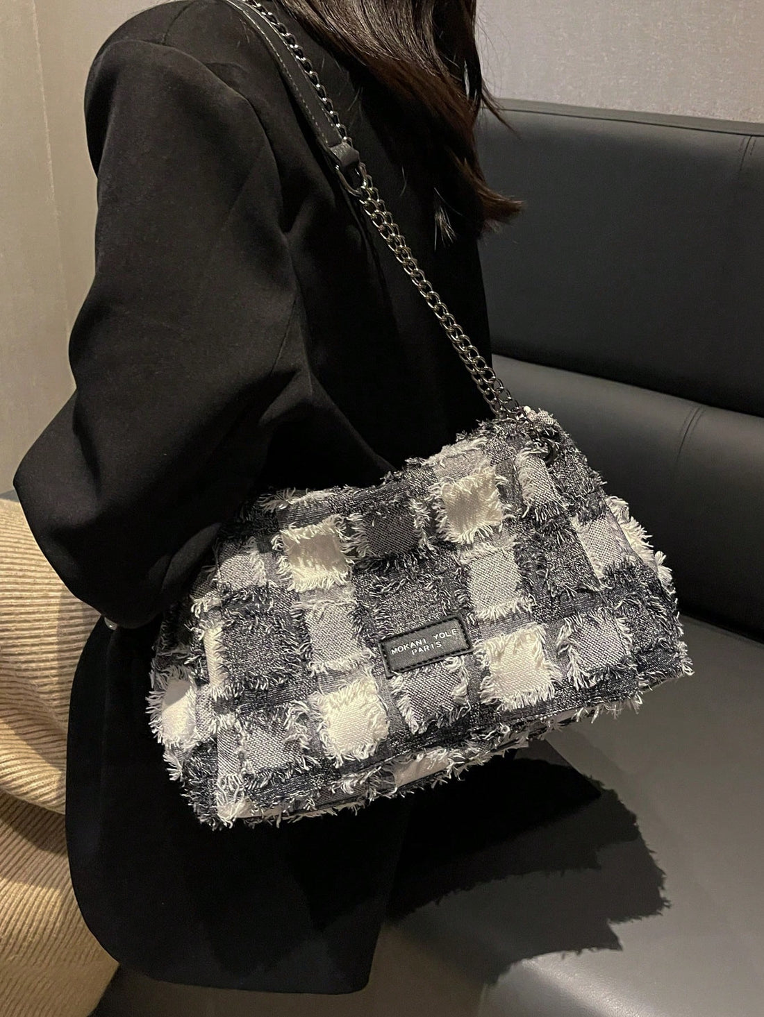 The Plaid Perfection large handbag with chain strap is the ultimate tote bag for women. Its stylish plaid design and sturdy chain strap make it the perfect accessory for any outfit. With its spacious size and durable construction, you can easily carry all your essentials while looking chic. Elevate your wardrobe with this must-have accessory.