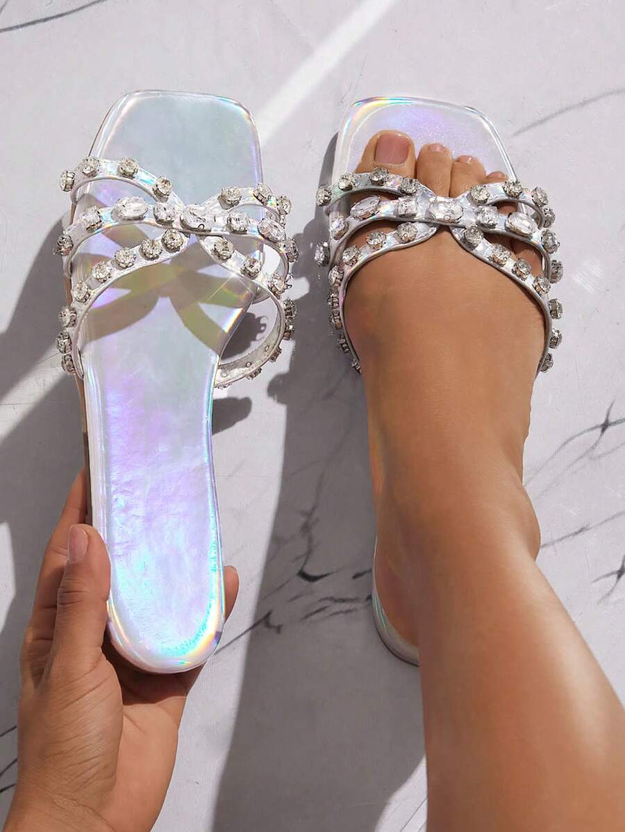 Step up your shoe game with these stylish sandals! Featuring a metallic finish and strappy stones, these square toe flats add a touch of glamour to any outfit. Perfect for adding a little sparkle to your step, these sandals are a must-have for any fashion-forward individual.