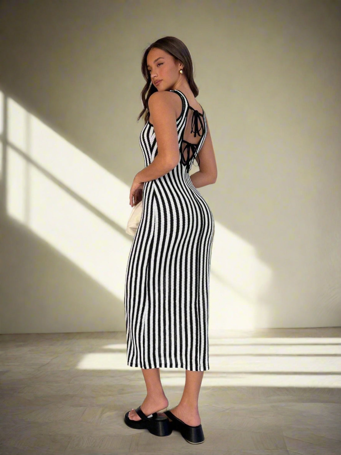 Step up your summer style with our Chic Striped Lace-Up Back Sleeveless Dress. Made for a stylish and comfortable look, this dress features a striped pattern and a lace-up back that will make you stand out in any crowd. Elevate your wardrobe with this must-have piece.