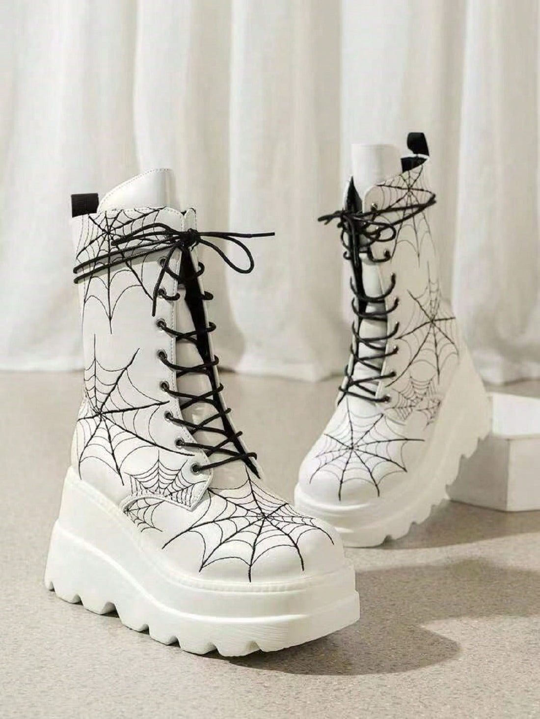These White Spider Embroidered Thick-Soled Boots are the perfect combination of fashion and function. With a stylish high heel design and mid-calf length, these boots will elevate any outfit. The thick-soled construction provides superior comfort and stability, making these boots ideal for all-day wear. Step out with confidence and style in these must-have boots for women.