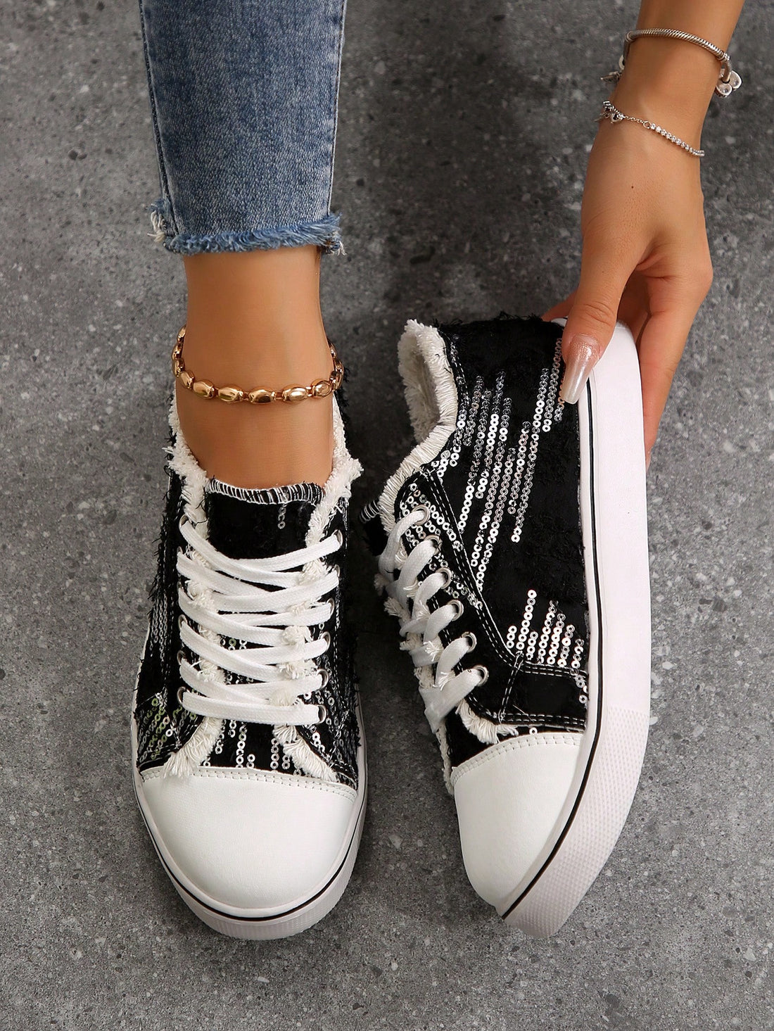 Step up your skateboarding game with our Black Glitter Fringed Athletic Shoes! These shoes feature a unique black glitter design with fringed accents that will make you stand out on your skateboard. Stay stylish and comfortable while you perform your best tricks.