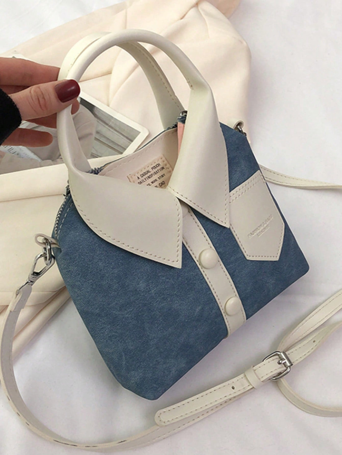 Introducing the Spice Girl Style Satchel, a chic and versatile handheld bag designed for the modern woman. With its simple shirt design and spacious interior, this satchel combines fashion and functionality. Upgrade your style game with this must-have accessory.