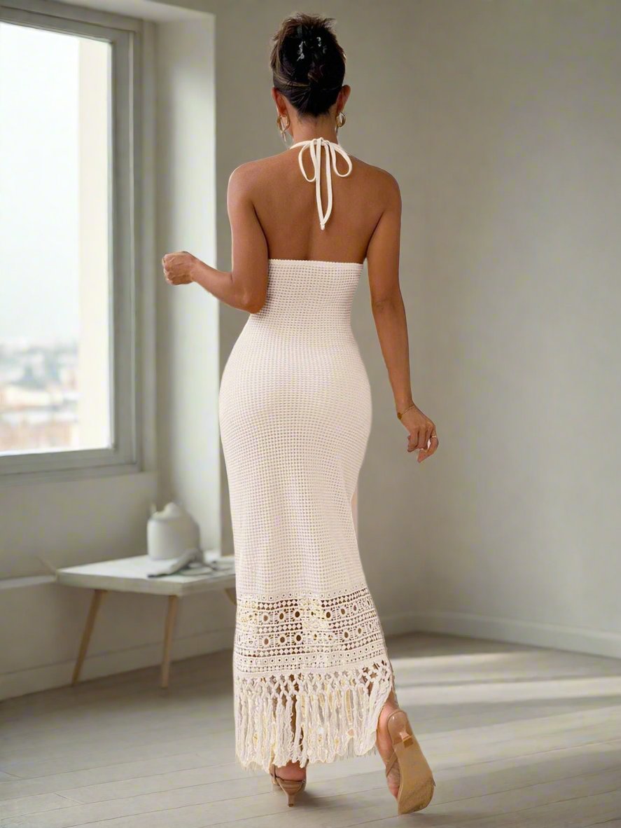 This elegant dress offers a flattering halter neck design and sleeveless construction. Made with a unique fringed hem, this dress is versatile for casual occasions and comfortable to wear. Enjoy effortless style with this timeless piece.