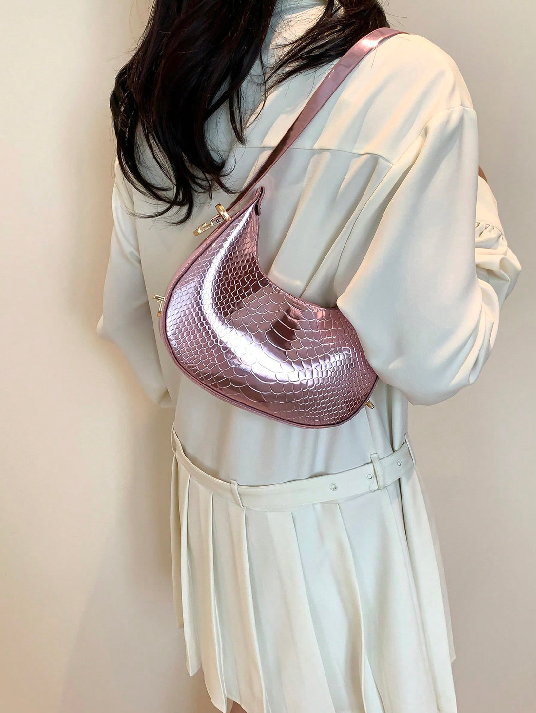 Introducing our Chic Metallic Snakeskin Hobo Bag, a trendy accessory that effortlessly elevates your style. The crocodile embossed design adds a touch of luxury while the spacious hobo style offers practicality. With its metallic sheen, this bag is perfect for any occasion. Experience effortless style now.