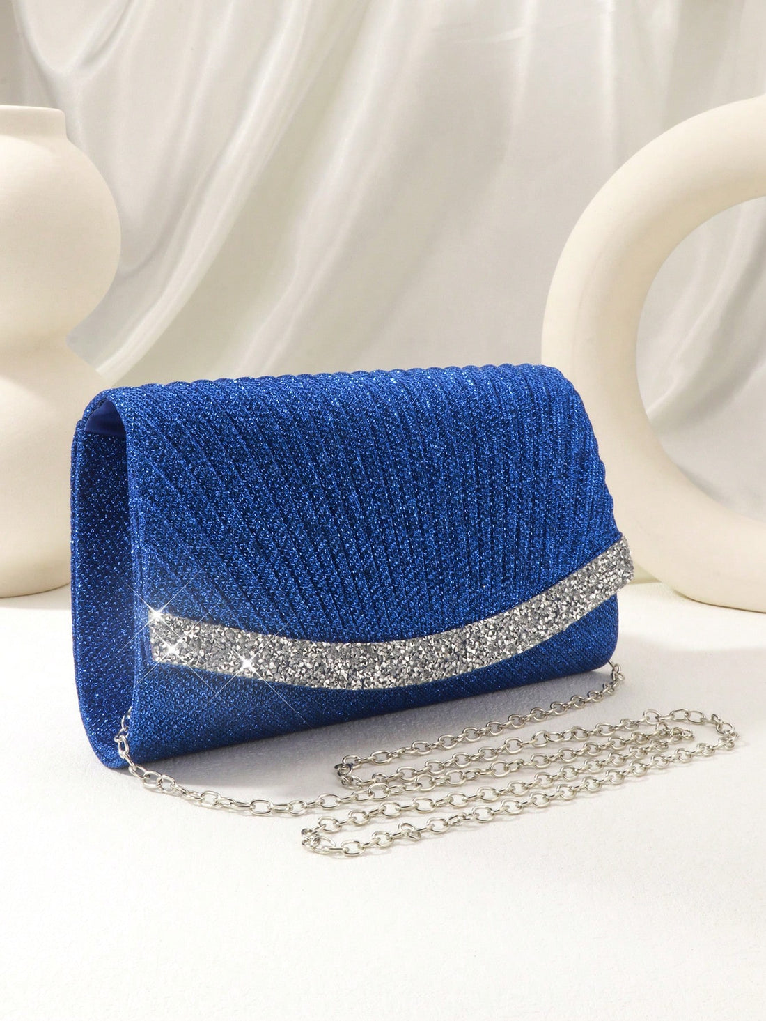 Introducing the Sparkling Elegance evening bag, the perfect accessory to add some glamour to any outfit! This miniature bag features stunning glitter and rhinestone decorations, making it a sparkling statement piece. Elevate your evening look with this elegant and eye-catching bag.
