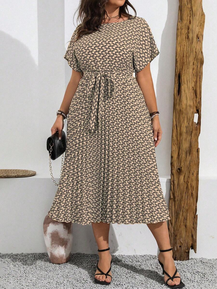 Front three-quarter view of khaki geometric plus size maxi dress with self-tie belt