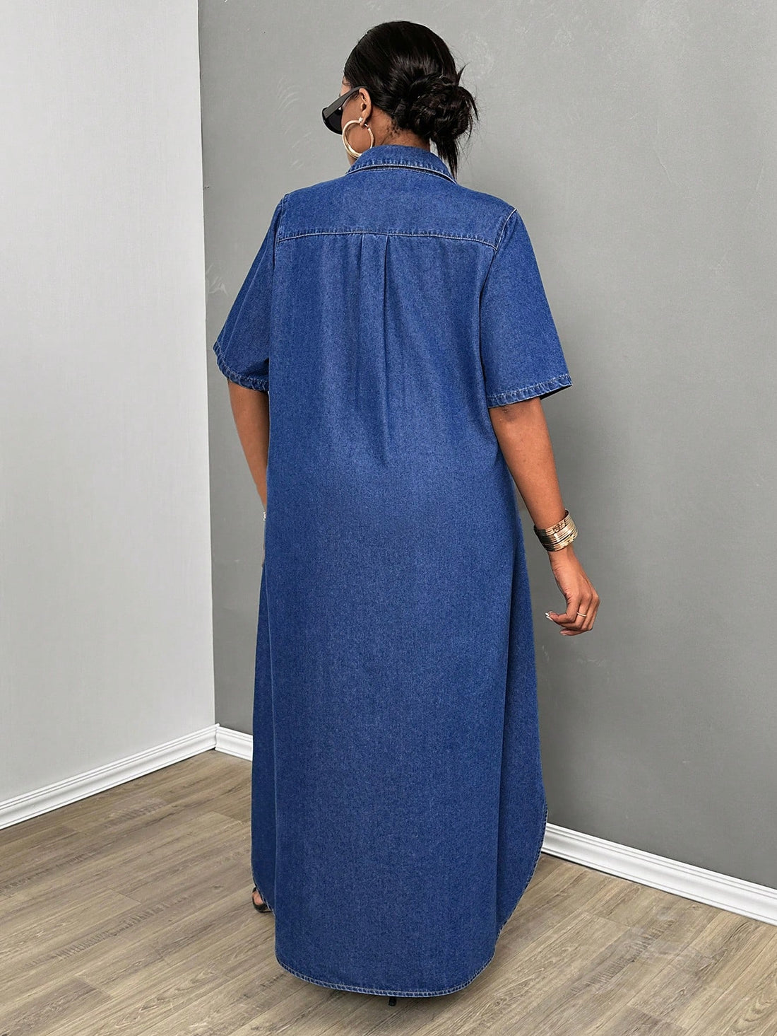 Look chic and stylish in our Plus Size Denim Shirt Dress, perfect for back to school. This versatile dress combines comfort and style, making it a must-have for any wardrobe. Its classic denim material and design will have you feeling confident and fashionable.