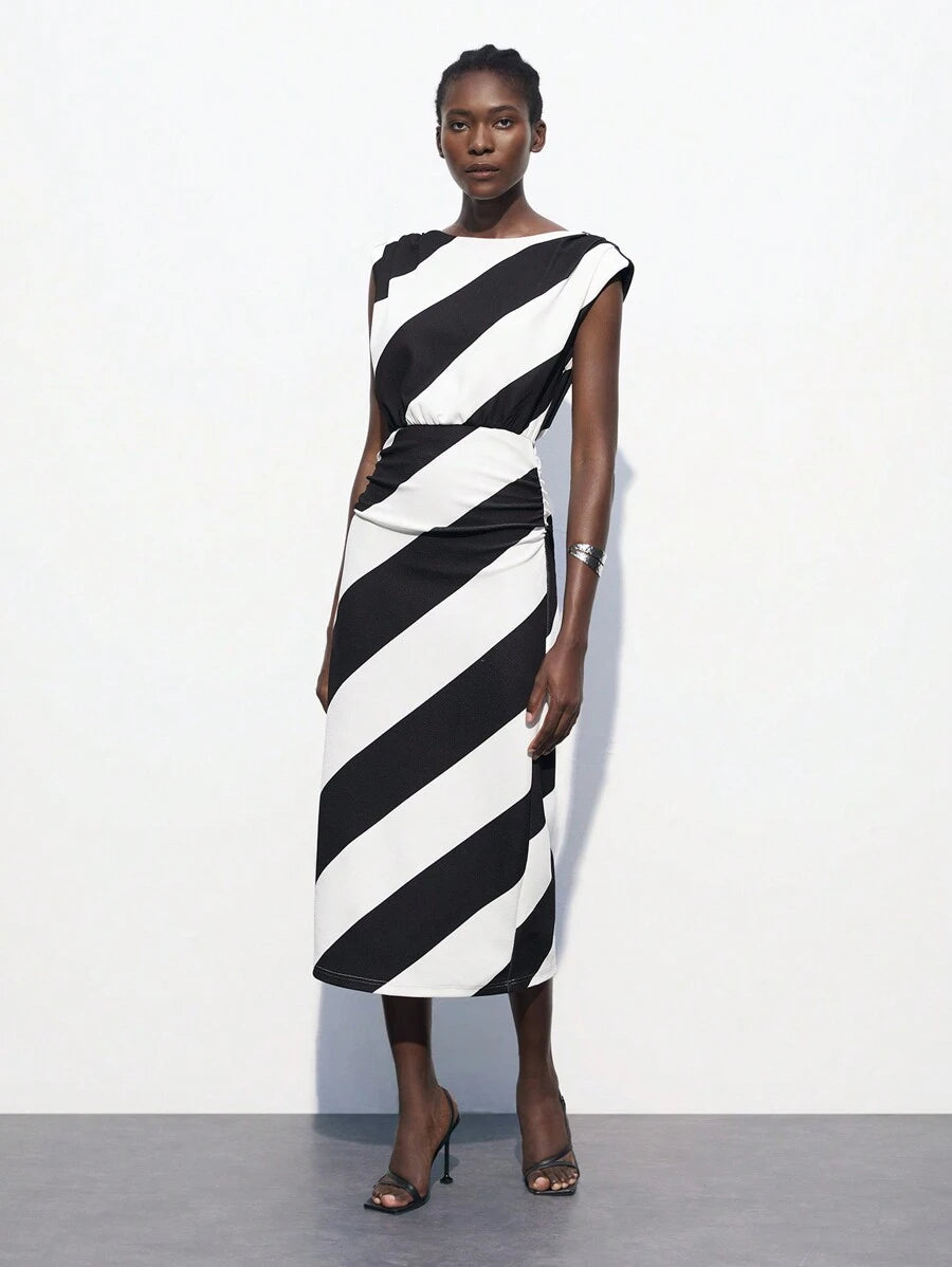 Stripes never go out of style—especially when they're this chic! This green and white striped dress features a flattering waist-cinching design that creates an instantly polished silhouette. Perfect for transitioning from summer into fall, it's your go-to piece for business-casual settings where you want to look put-together without trying too hard. Pair it with sneakers for a relaxed vibe or dress it up with heels for the office. Versatile, timeless, and undeniably elegant.