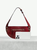 Statement shoulder bag with crocodile texture and metal accents