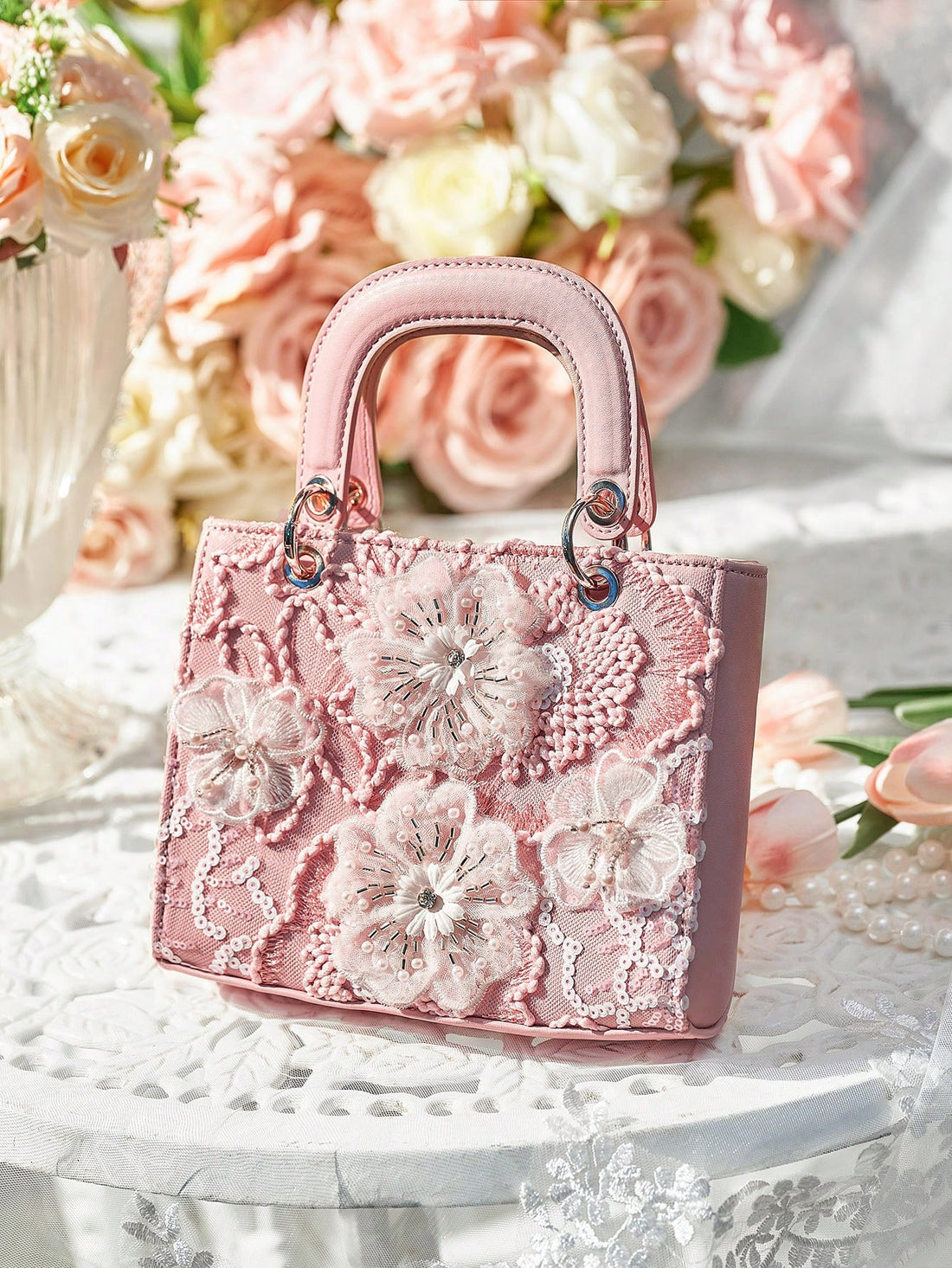 Expertly designed for elegant occasions, this Floral Top Handle Evening Bag will elevate your style at weddings, parties, and special occasions. With its delicate floral details and convenient top handle, this bag is both beautiful and practical. Make a statement with this must-have accessory.