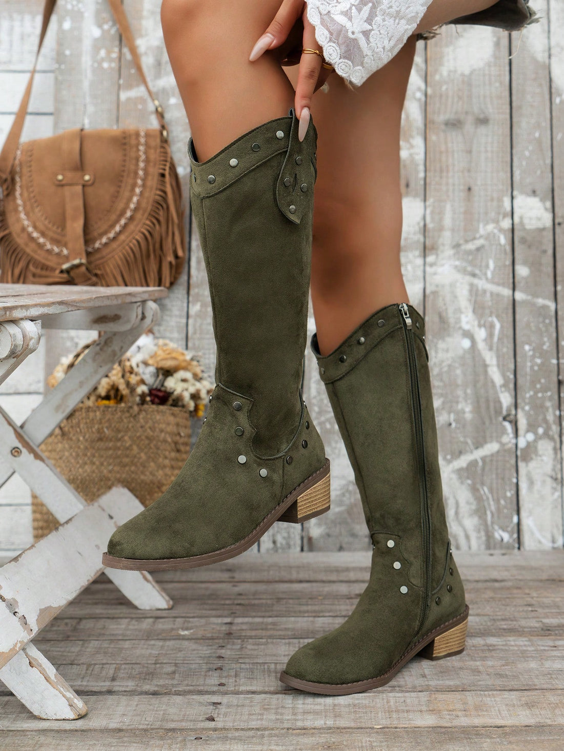 Elevate your style this fall and winter with our Chic Olive Green Studded Knee-High Western Cowboy Boots. Made with high-quality materials, these boots offer both comfort and fashion. The studded design adds a unique touch to your outfit, while the knee-high length keeps you warm. Perfect for any stylish look.