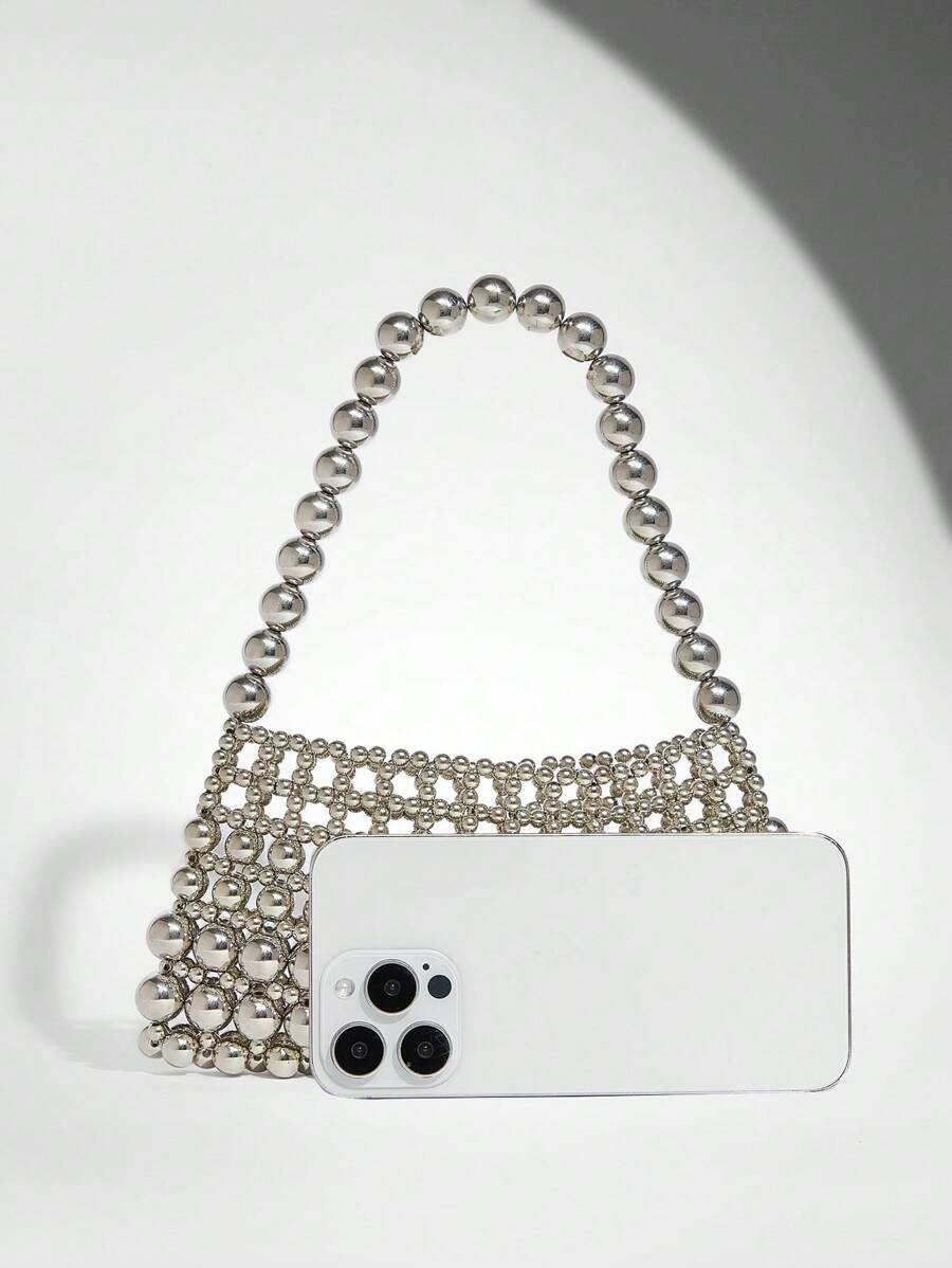Add a touch of sparkle to your outfit with this Elegant White Pearl Beaded Shoulder Bag. Perfect for any occasion, its shimmering pearls and sleek design make it a playful yet sophisticated accessory that effortlessly elevates your style. Carry your essentials in chic fashion and turn heads wherever you go!