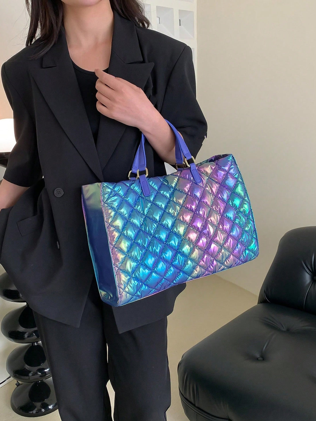 Elevate your style with our Shimmering Elegance: Holographic Quilted Top Handle Bag. This stunning bag features a holographic quilted design and a convenient top handle for easy carrying. Perfect for adding a touch of glamour to any outfit.