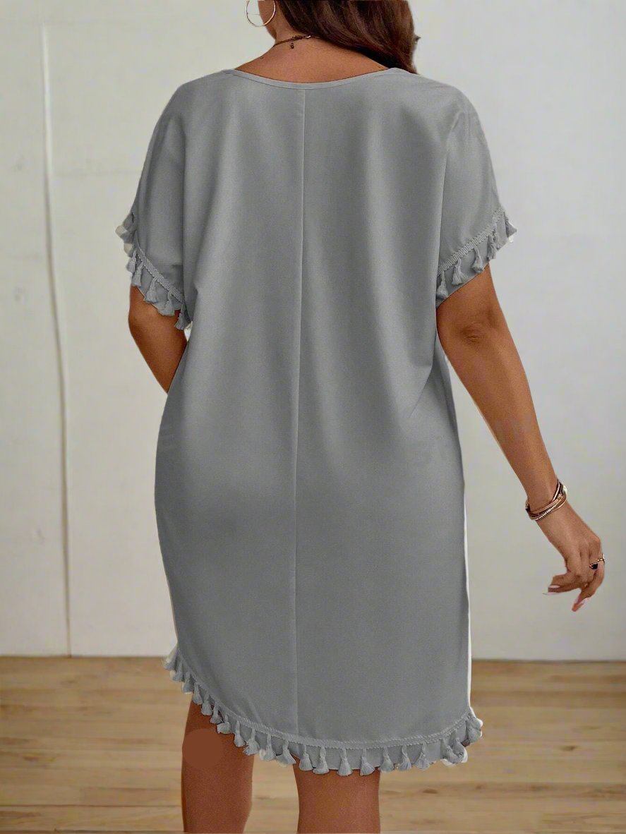 Expertly designed for plus-size women, this chic dress features a trendy geometric pattern and playful tassel detailing. Boost your confidence with its flattering fit and elevate your style with its unique design. Perfect for any occasion, this dress is a must-have addition to your wardrobe.