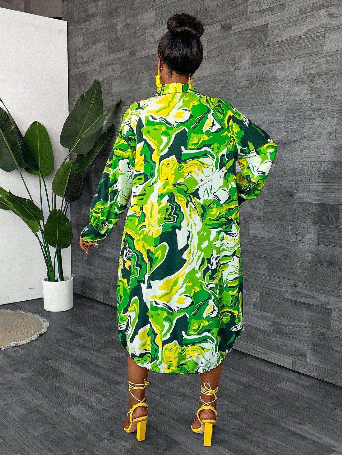 This dress is a playful addition to any wardrobe, with its chic all-over print and adjustable drawstring waist. The button front adds a touch of charm, making it perfect for any occasion. Stay stylish and comfortable in this quirky dress.