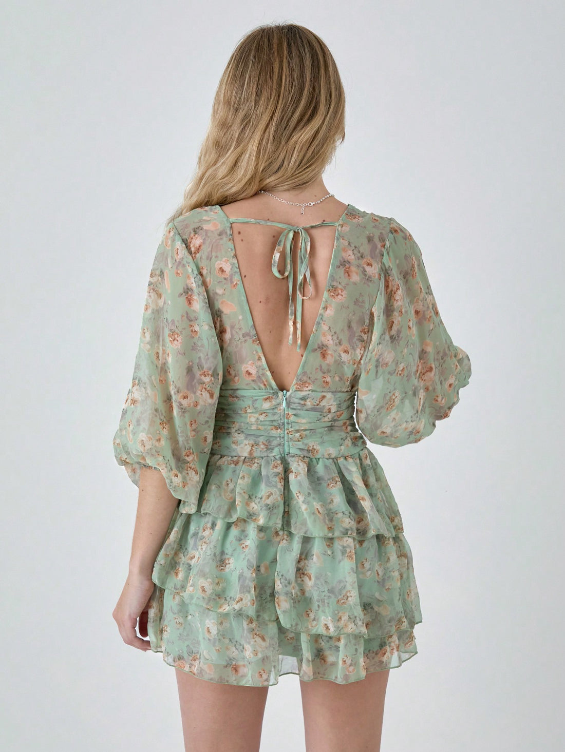 This dress is cute and charming, with a ditsy floral print that adds a touch of whimsy. The lantern sleeves and ruffle hem give it a playful and flirty look. Perfect for any occasion, this mini dress is sure to make you stand out from the crowd!