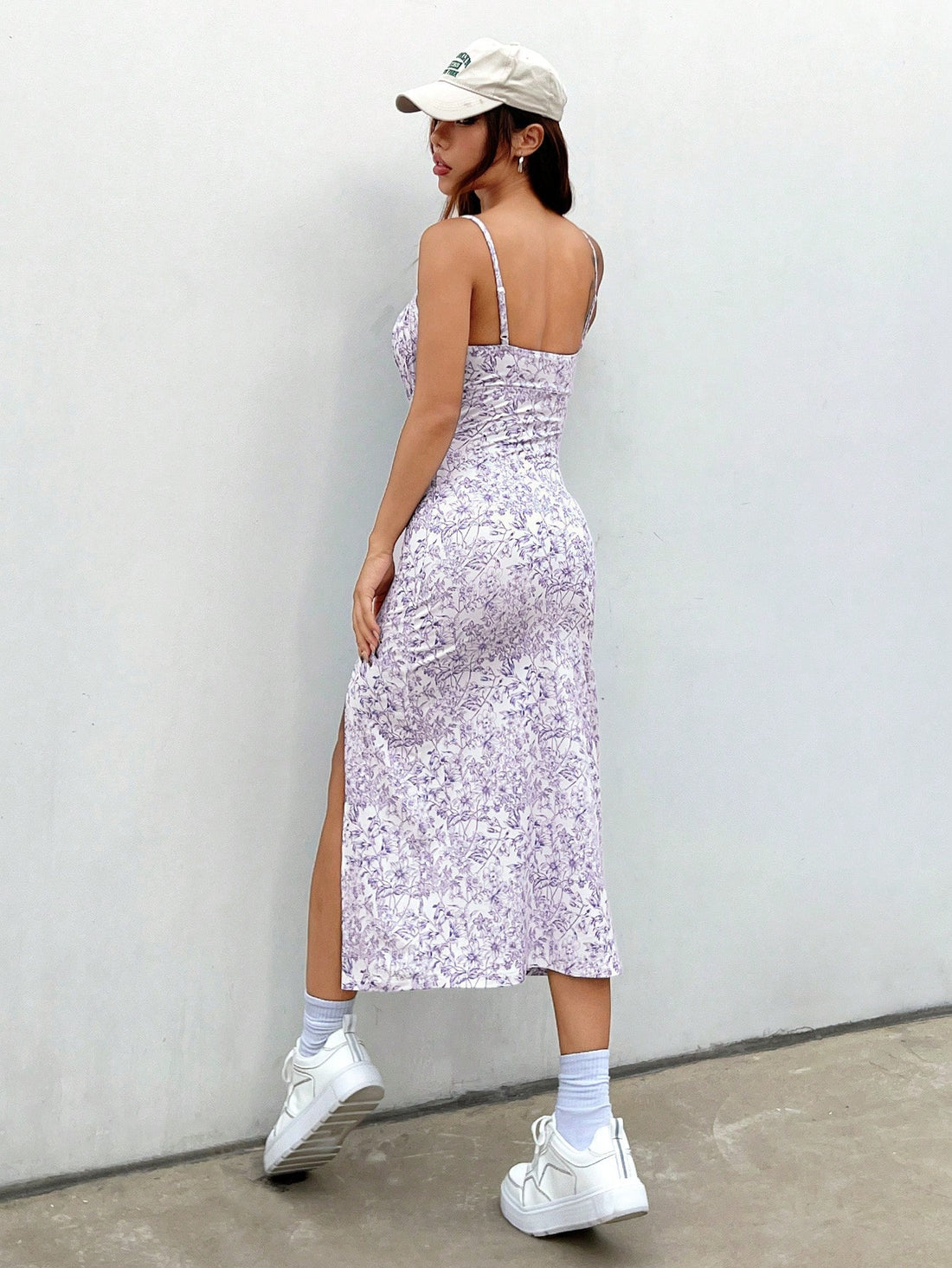 Flaunt your elegant and playful side with our Porcelain Floral Print Dress! Featuring a backless design and spaghetti straps, this dress is perfect for showing off your summer glow. The front slit adds a flirty touch to this stunning piece. Get ready to turn heads and make a statement in this must-have dress!