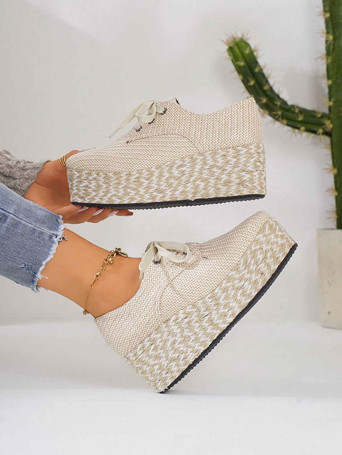 Step up your style game with these chic beige wedge platform shoes! Made from suede material and featuring a lace-up design, these shoes provide both comfort and fashion. With their dual-tone rope soles, they add a unique touch to any outfit. Elevate your look with these expertly-crafted shoes.
