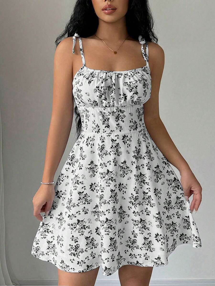 Effortless elegance meets playful style with this women's floral print camisole dress. The twist front ruching creates a flattering silhouette while the mini length keeps things fresh and modern. Perfect for casual outings, brunch dates, or weekend adventures. The vibrant floral pattern adds a feminine touch that works year-round. Pair with sneakers for laid-back charm or dress up with heels for an evening out. A versatile wardrobe essential that transitions seamlessly from day to night.