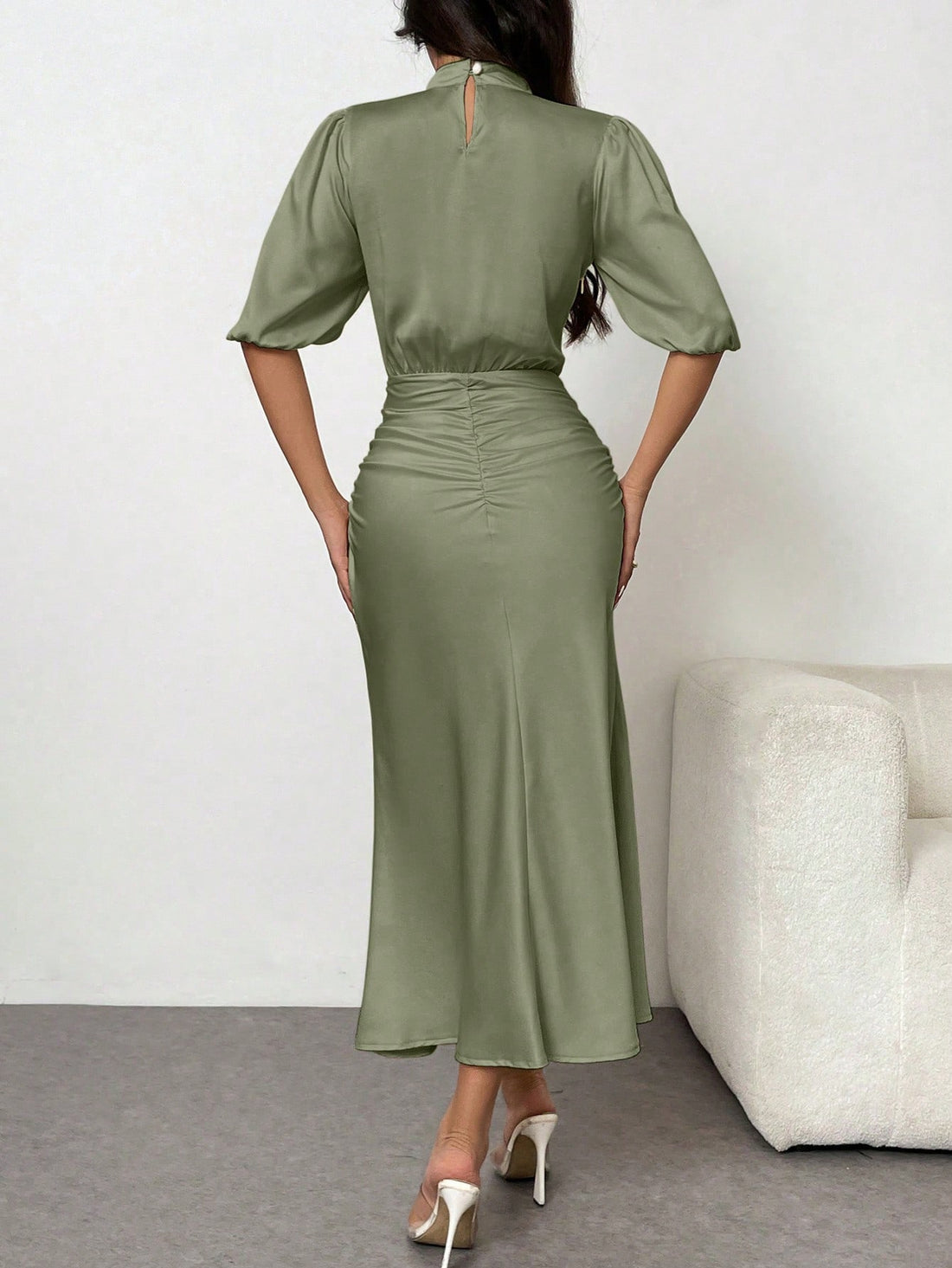 This elegant Puff Sleeve Satin Dress features a cinched waist and fishtail hem, creating a flattering silhouette. The lightweight satin fabric adds sophistication, making it perfect for special occasions. The puff sleeves add a touch of femininity to this timeless dress.