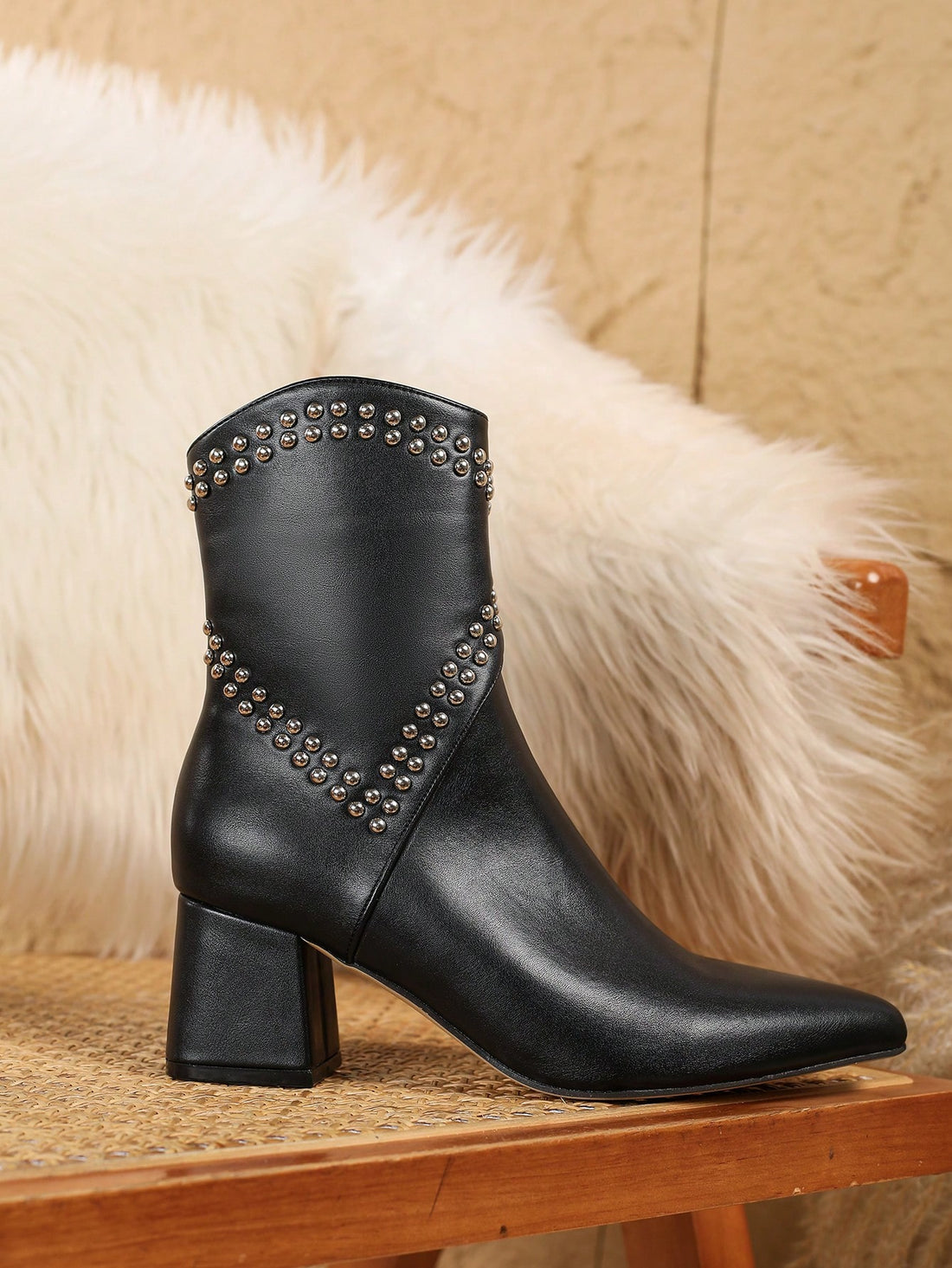 Elevate your style with our Rivet Decor Pointed Toe Chunky Heel Black Boots. Whether you're dressing up for a night out or completing a casual look, these boots are the ultimate combination of sexy and versatile. The pointed toe and chunky heel add a touch of sophistication, while the rivet decor adds a hint of edge. 