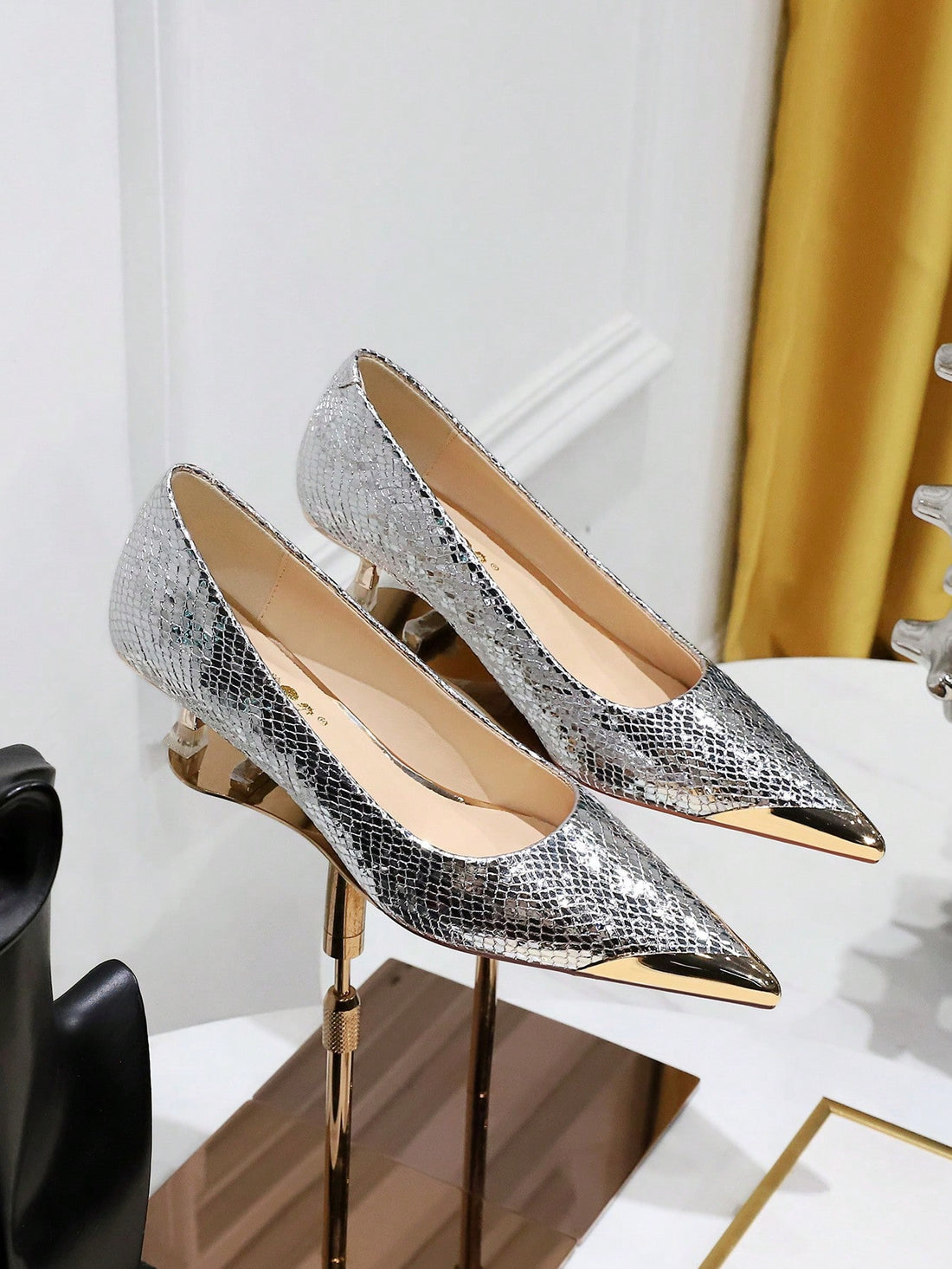 Add a touch of metallic snakeskin to youElevate your style with our Shimmer and Shine: Metallic Snakeskin Party Pumps! These pumps feature a unique combination of metallic snakeskin material and mid heels, adding a touch of glamour to any outfit. Walk with confidence and make a statemer party look with these shimmering pumps. The mid-height heels provide just the right amount of lift, while the unique texture adds a glamorous edge to any outfit. Step out in style with these luxurious and eye-catching shoes.