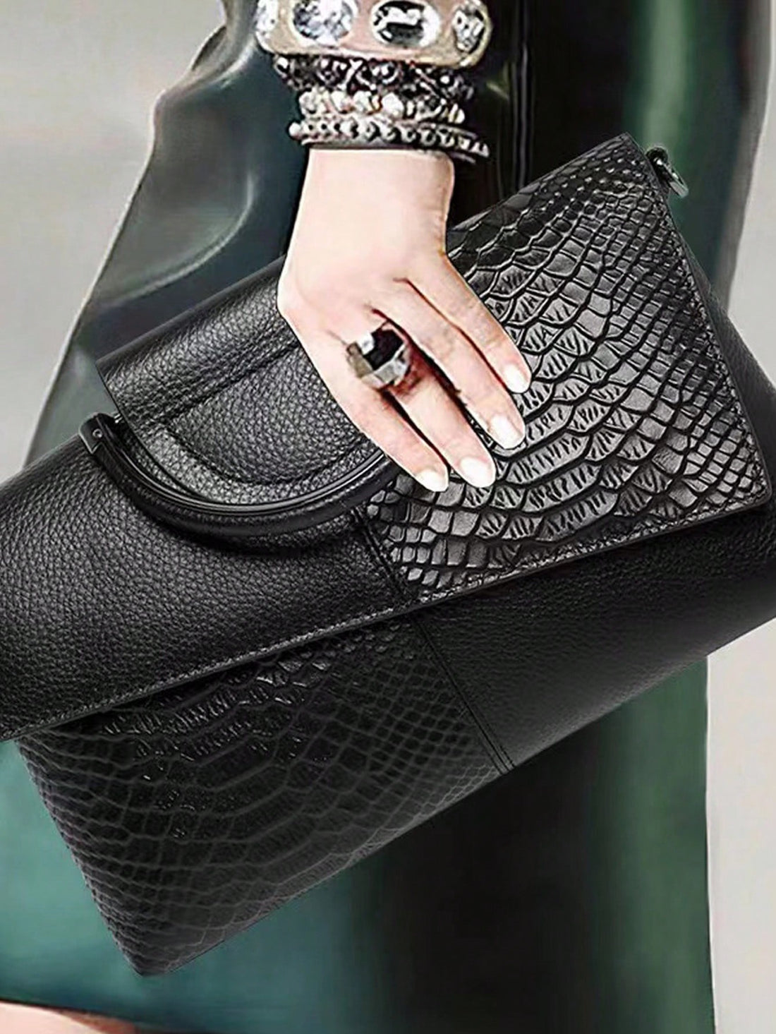 Add a dash of wild sophistication to your outfit with this chic black handbag featuring a sleek snake skin pattern. Perfectly sized for your essentials, it effortlessly transitions from casual day outings to elegant evening events. Carry confidence and style wherever you go!