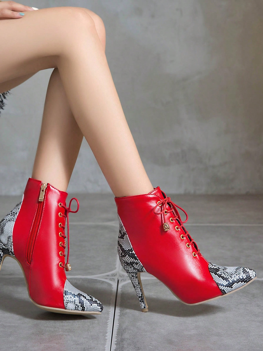 Elevate your style with our stylish snake skin print stiletto boots. Featuring a convenient side zipper and trendy lace-up detail, these boots are perfect for any fashion-forward individual. Walk with confidence and make a statement.