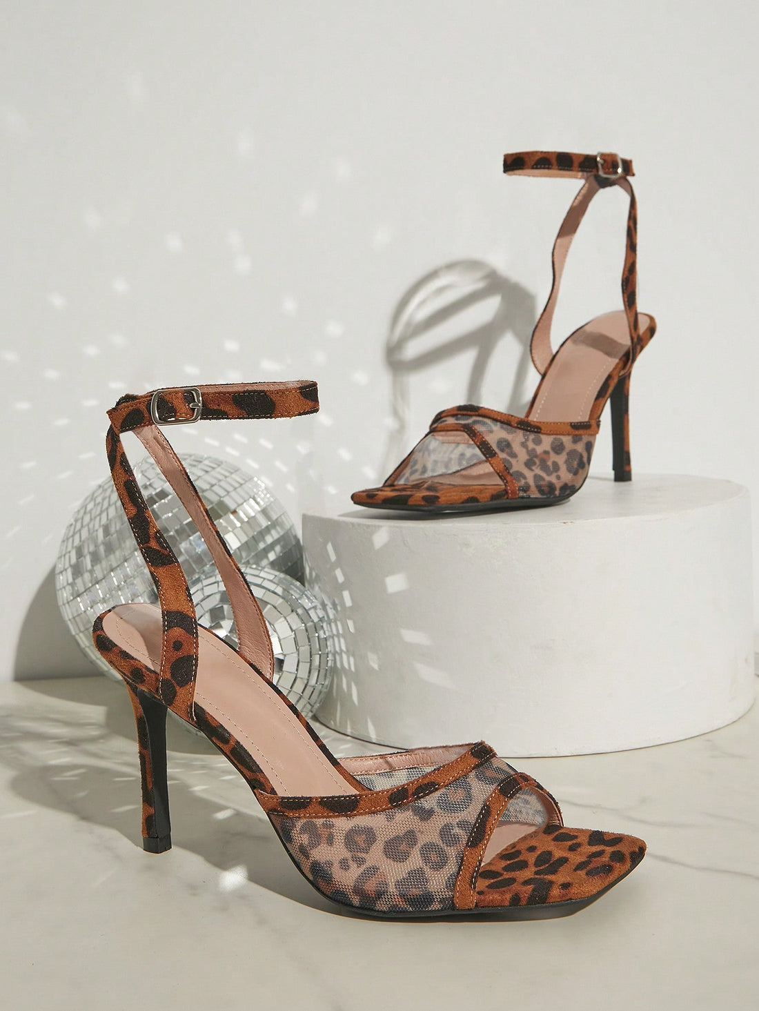 Elevate your style with our Chic Leopard Mesh Ankle Strap High Heel Sandals. Made for trendy women, these sandals feature a sleek, leopard print mesh design and a secure ankle strap for a comfortable fit. Perfect for any occasion, these sandals add a touch of sophistication to any outfit.